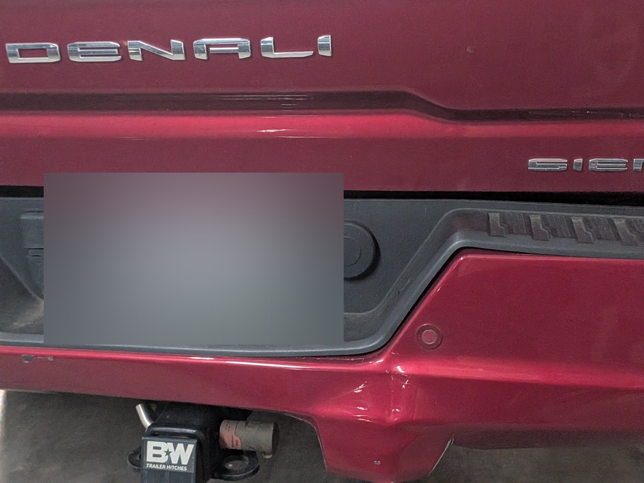 GMC Sierra Denali rear bumper damage before repair